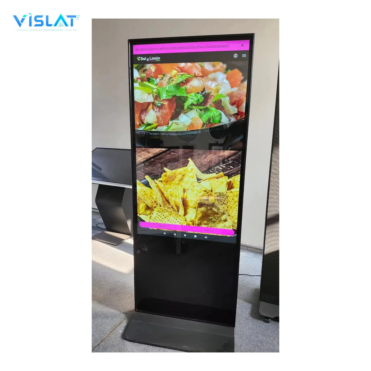 VISLAT 24 inch battery powered portable digital signage unit standing on the factory floor